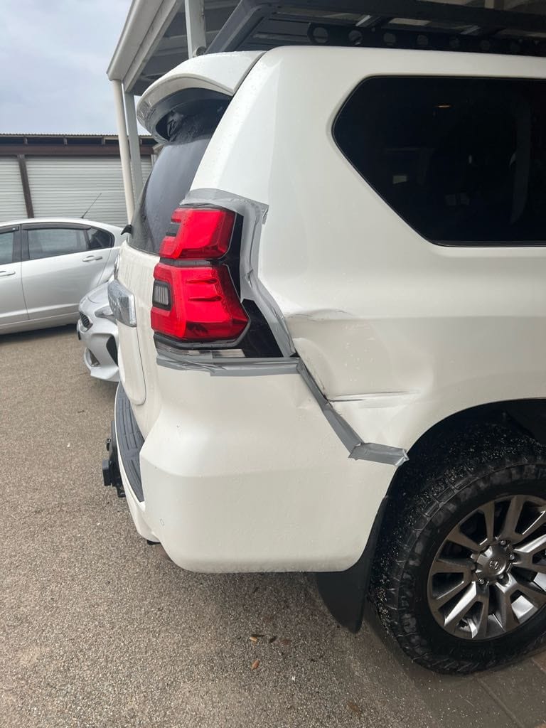 Toyota Land Cruiser Prado with collision damage to the rear quarter panel as it arrived at the workshop