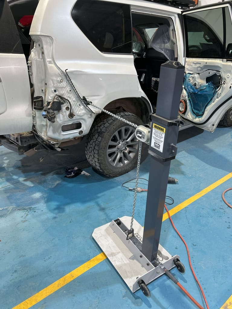 Prado rear quarter stripped back and drawn out on the workshop's pulling equipment