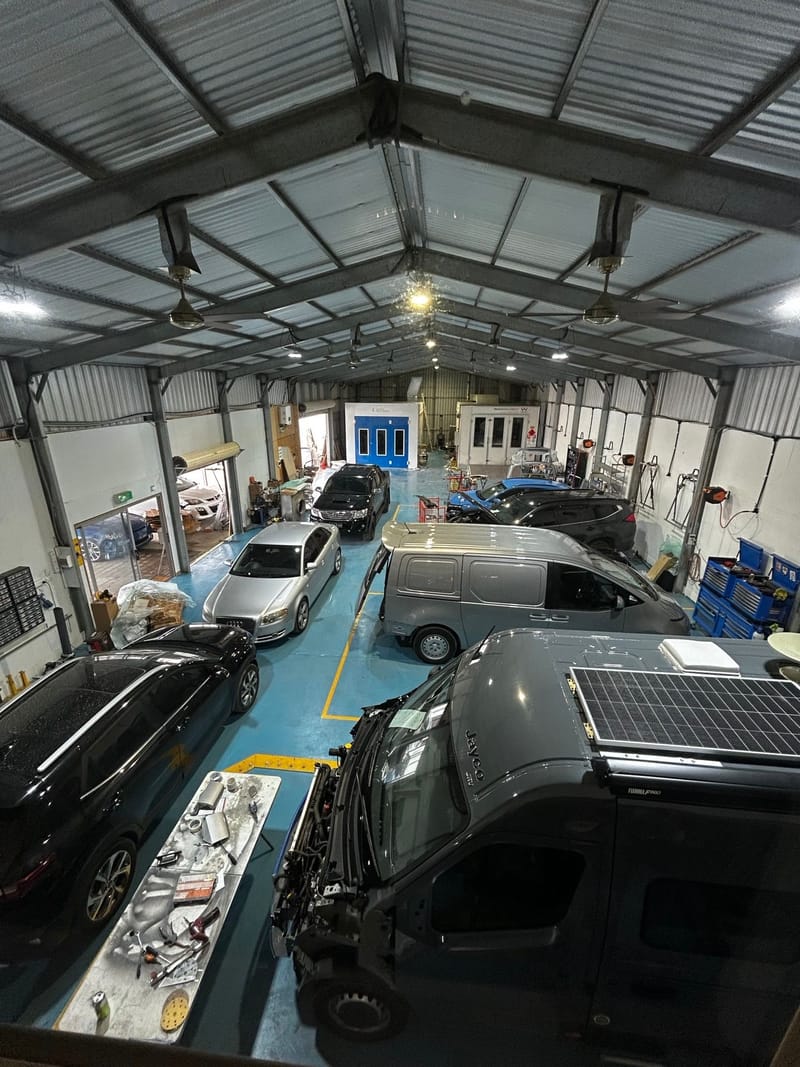 Vehicles being repaired inside the Aldinga Crash Repairs workshop